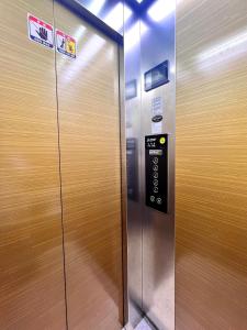 an elevator with a door with a sign on it at HeiStay-30sec from Hongdae SubwayStop-Elevator in Seoul