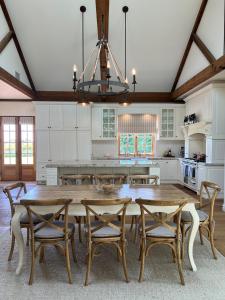 a kitchen with a large wooden table and chairs at Ciel House - French style in Angaston
