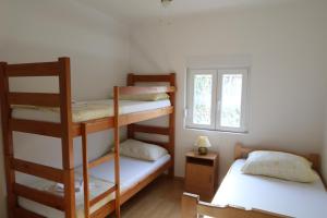 a room with two bunk beds and a window at Antodo Alen in Novalja