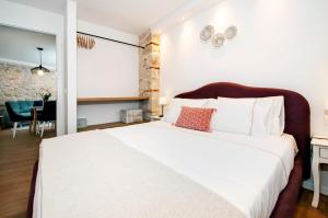 Ένα ή περισσότερα κρεβάτια σε δωμάτιο στο Apartmani De Amicis