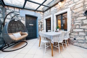 a patio with a table and chairs and a building at Atrium Town House in Rovinj