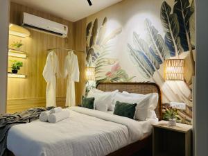 a bedroom with a bed with towels on it at BluO Penthouse #staycation Bathtub, Terrace Garden in Gurgaon