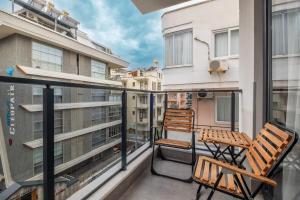 a balcony with two chairs and a bench on it at Camelia 9 in Alanya