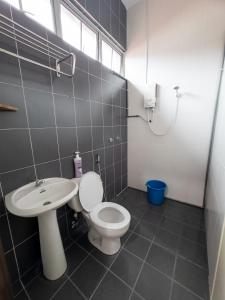 a bathroom with a white toilet and a sink at Hi-Tea HomeStay in Sungai Petani +21 photos