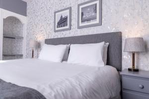 a bedroom with a large bed with white pillows at Cromwell Lodge Hotel by Greene King Inns in Banbury