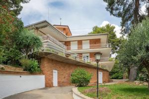 a house with a staircase on the side of it at VILLA Mar y Montaña in Castelldefels