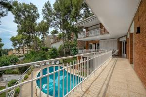 a balcony of a house with a swimming pool at VILLA Mar y Montaña in Castelldefels