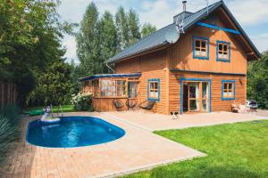 a house with a pool in front of it at Przystanek Jeziorna 49 in Perlino