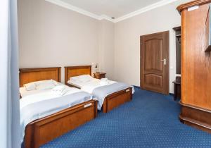 Postel nebo postele na pokoji v ubytování Hotel Marczewski