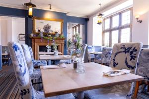 a dining room with a table and chairs at Cromwell Lodge Hotel by Greene King Inns in Banbury