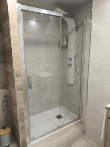 una ducha con puerta de cristal en un baño en Vivienda Turística La Cordobesa, en Córdoba 15 fotos más