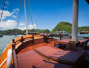 a deck of a boat in the water with benches at Halong Ocean Cruise 6 in Ðảo Cát Bà