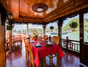 a dining room with a table with a red table cloth at Halong Ocean Cruise 6 in Ðảo Cát Bà