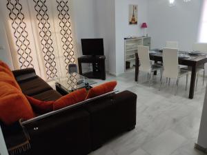 a living room with a couch and a dining table at Apartamento torrox in Torrox Costa