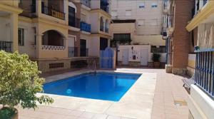 a swimming pool in the courtyard of a building at Apartamento torrox in Torrox Costa