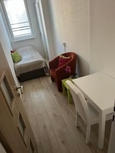 a small room with a table and a chair at Budget Single Room Old Town in Košice