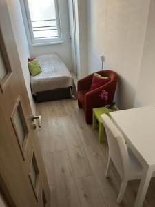 a small room with a chair and a bed at Budget Single Room Old Town in Košice
