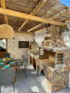an outdoor kitchen with a stone fireplace in a house at City Compass Sunset Villa in Rhodes Town +35 photos