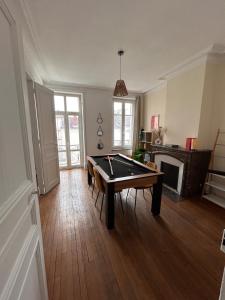 a living room with a ping pong table in it at Bel appartement centre gare in Nancy