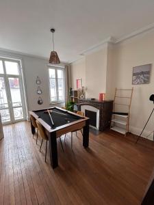 a living room with a pool table and a fireplace at Bel appartement centre gare in Nancy