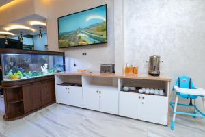 a room with a fish tank and a tv on the wall at Maarif elite suites in Casablanca