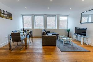 a living room with a couch and a table at Sussex House in Reading