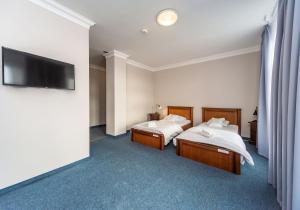 Postel nebo postele na pokoji v ubytování Hotel Marczewski