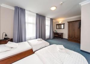 Postel nebo postele na pokoji v ubytování Hotel Marczewski