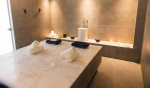 a bathroom with a sink and a counter with towels at Lindos Royal Resort in Líndos
