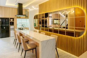 a kitchen with a dining table and chairs at Rasafie Dago Villa in Bandung