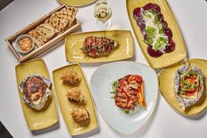 a group of plates of food on a table at Lindos Royal Resort in Líndos