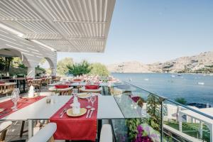 a restaurant with a view of the water at Lindos Royal Resort in Líndos