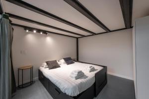 a bedroom with a bed with white sheets and pillows at New Luxury Loft - Prada-Bocconi in Milan