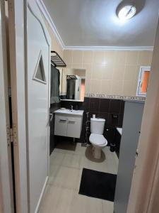 a small bathroom with a toilet and a sink at Un appartement cosy in Oujda +6 photos