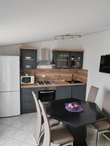 a kitchen with a table and chairs in a kitchen at Apartments Tanja & Josipa in Pag
