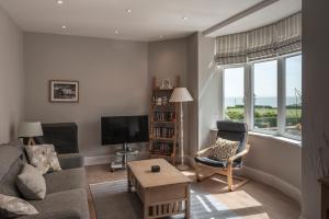 a living room with a couch and a tv at Carlton Lodge, Two bedroom apartment with parking space in Broadstairs