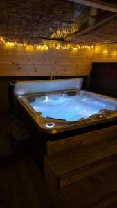 a bath tub filled with blue water with lights at The Escape in Ellesmere Port
