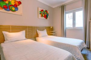 two beds sitting next to each other in a room at SEA URCHIN MILFONTES by Stay in Alentejo in Vila Nova de Milfontes