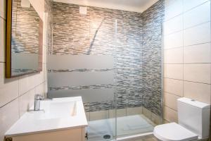 a bathroom with a sink and a toilet and a shower at SEA URCHIN MILFONTES by Stay in Alentejo in Vila Nova de Milfontes +23 photos