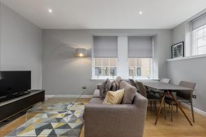 a living room with a couch and a table at Destiny Scotland Apartments at Canning Street Lane in Edinburgh