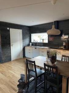 a kitchen with a table and chairs and a dining room at Pärla i Havsbaden in Ängelholm