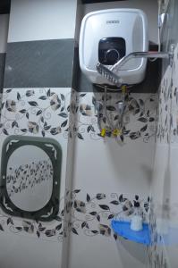 a bathroom with a hair dryer and a mirror at ViratHomestay in Varanasi