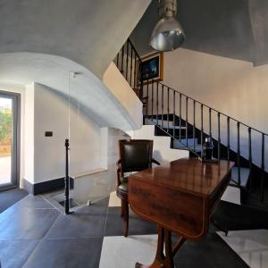 a living room with a piano and a staircase at AF1892rooms in Filignano