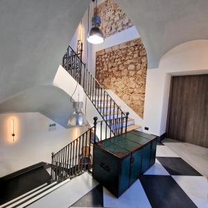 a staircase in a house with a stone wall at AF1892rooms in Filignano