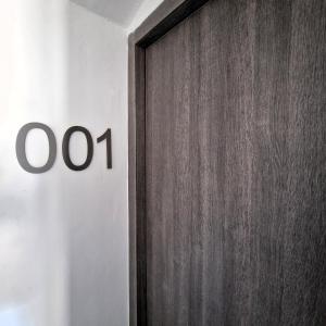 a wooden door with theok sign on a wall at AF1892rooms in Filignano
