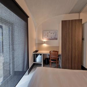 a bedroom with a bed and a desk with a chair at AF1892rooms in Filignano +16 photos