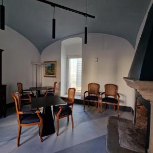 a living room with a table and chairs and a fireplace at AF1892rooms in Filignano +16 photos