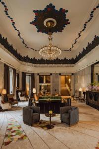 a lobby with a chandelier and a living room at Hotel Bristol, A Luxury Collection Hotel, Warsaw in Warsaw
