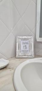 a picture of a bathroom with a white sink at Casa do Bairro - O seu refúgio in Ponta Delgada +21 photos
