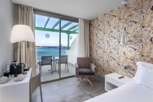 a hotel room with a view of the ocean at Barceló Teguise Beach - Adults Only in Costa Teguise